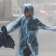 A woman is caught in the rain in the southern Chinese city of Shenzhen on Sunday.